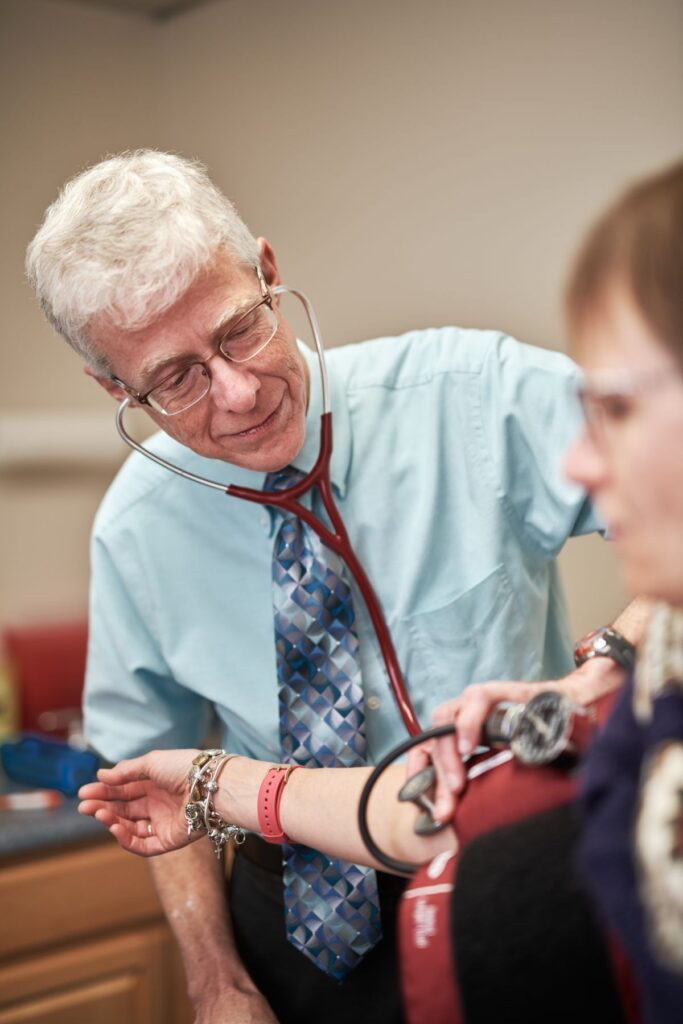 Doctor taking blood pressure of patient