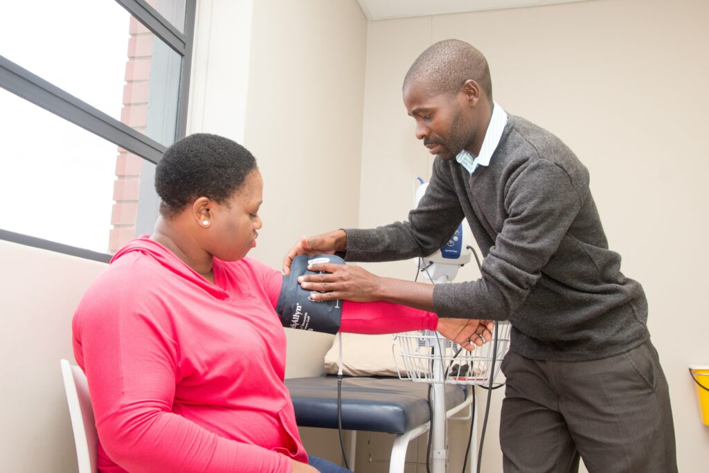 Doctor taking blood pressure of patient