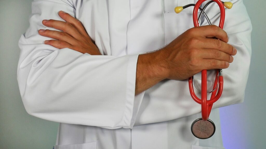 Doctor crossing arms and holding a stethoscope