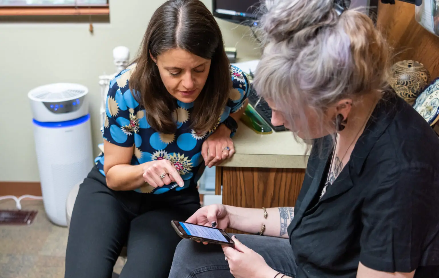 Doctor showing a patient how to log into their patient chart on Elation Go