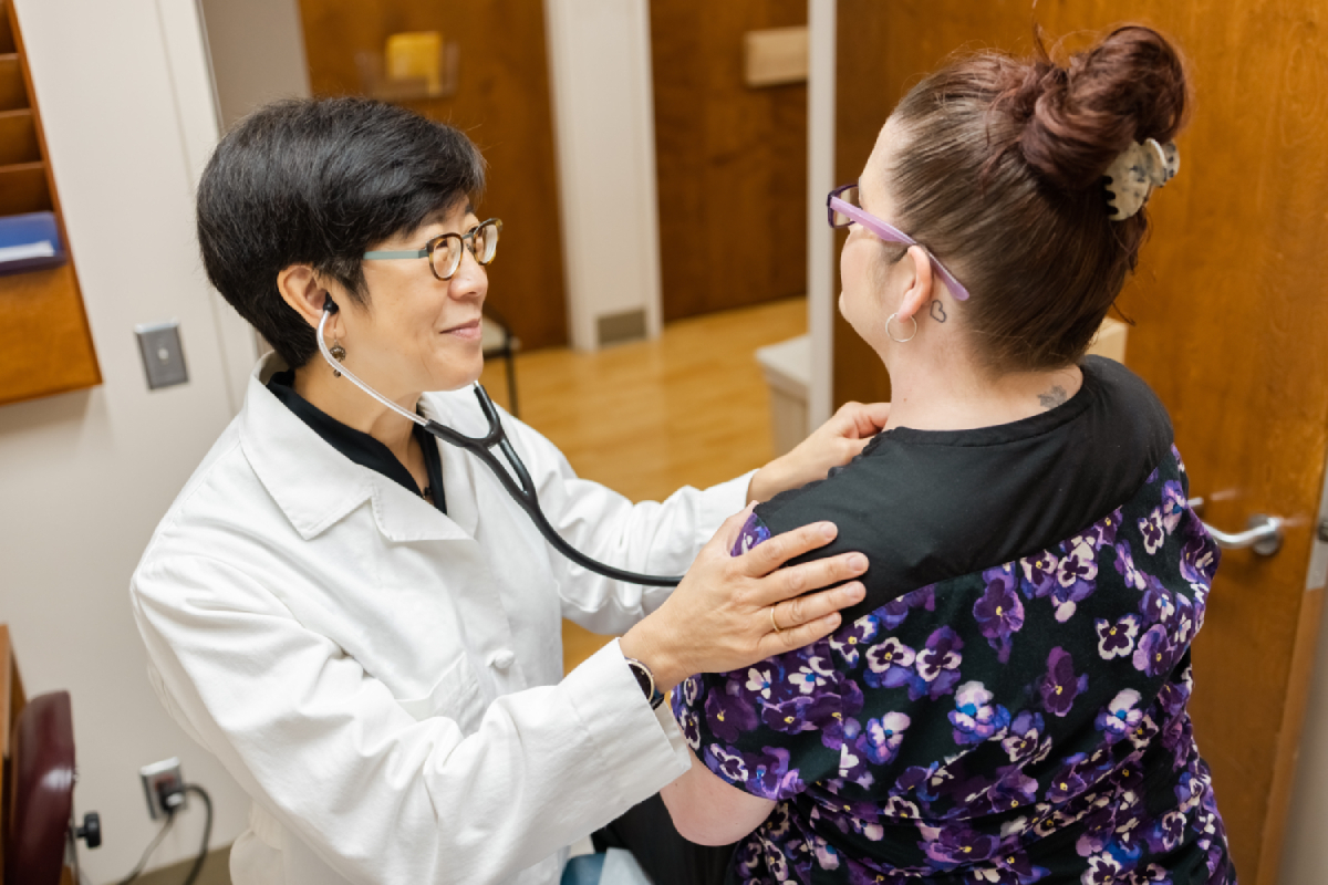 Doctor listening to patient's breathing